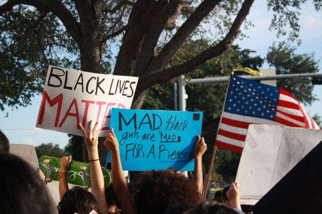 Black Lives Matter protestors hold up signs outside of McAllen City Hall. 